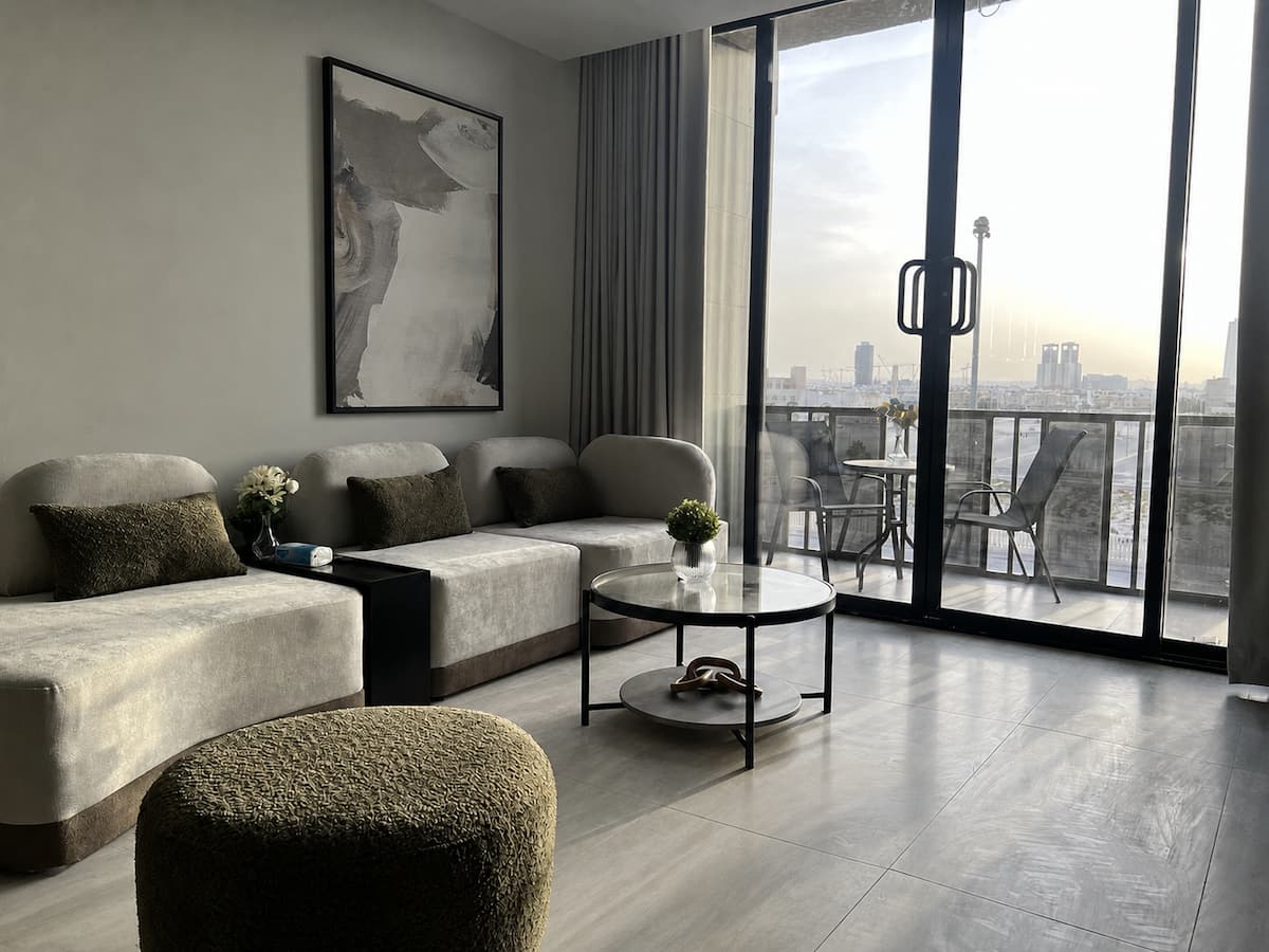 Modern Rihab apartment living room opening onto a city-view balcony